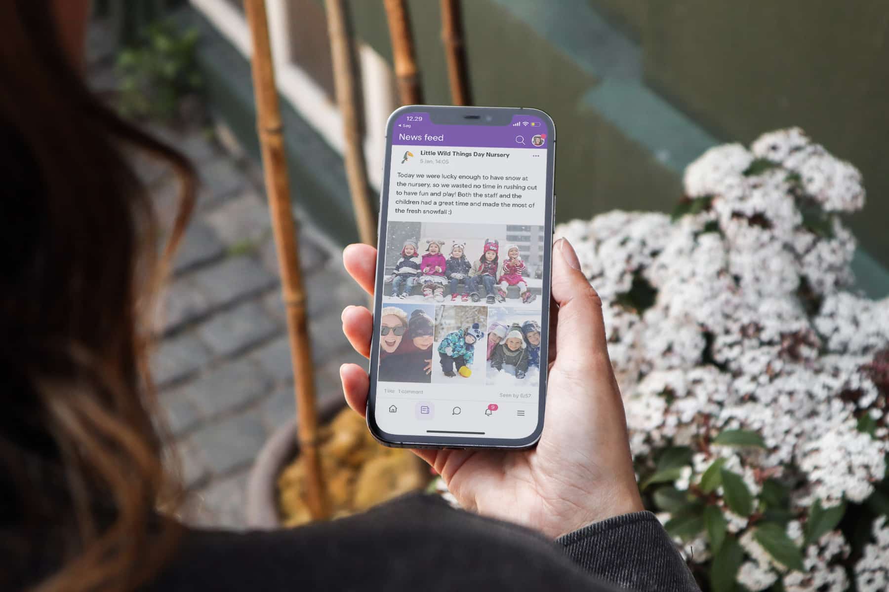women holding a phone viewing the famly app feed