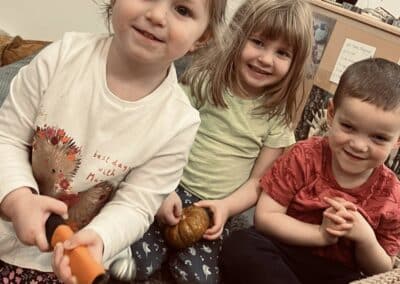 3 toddlers smiling for a photo